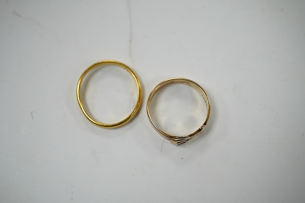 A modern 9ct gold buckle ring, 2.2 grams and a 22ct gold wedding band, 1.6 grams. Condition - poor